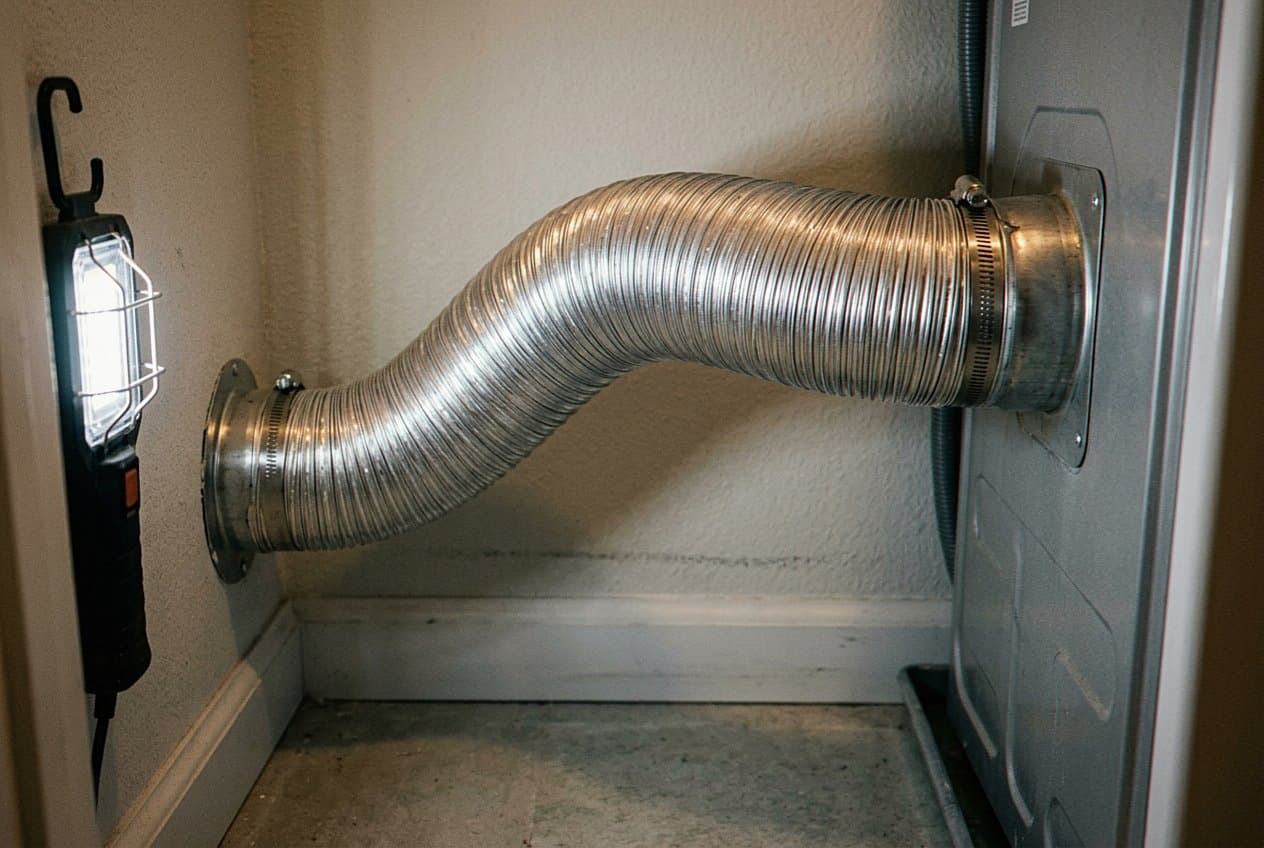 New metal hose clamped onto a dryer