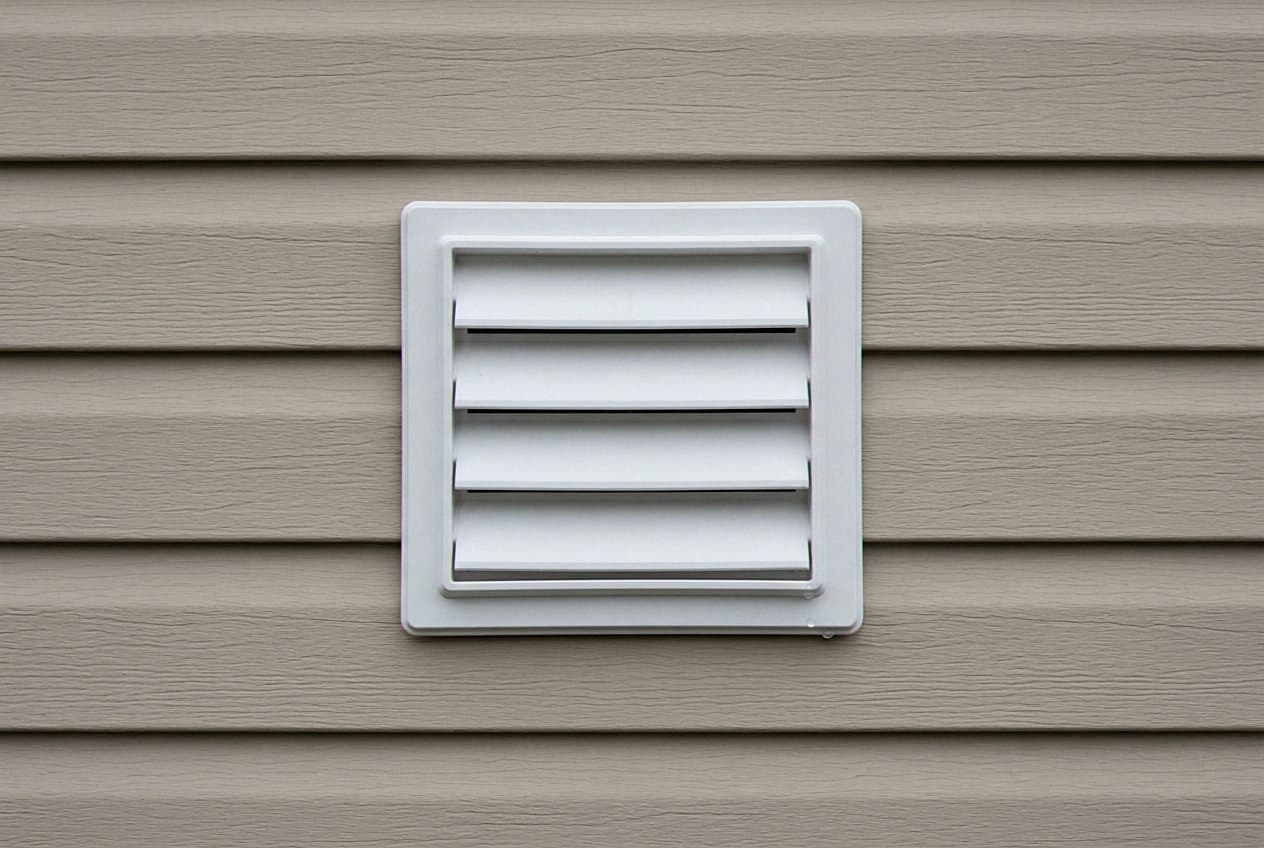 Clean white vent hood closed against tan siding
